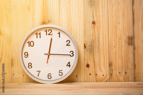 white clock on wooden background