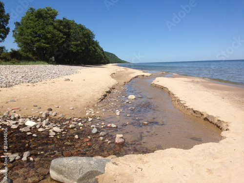 Small stream ends in the baltic sea near Stenshuvud in Scania photo