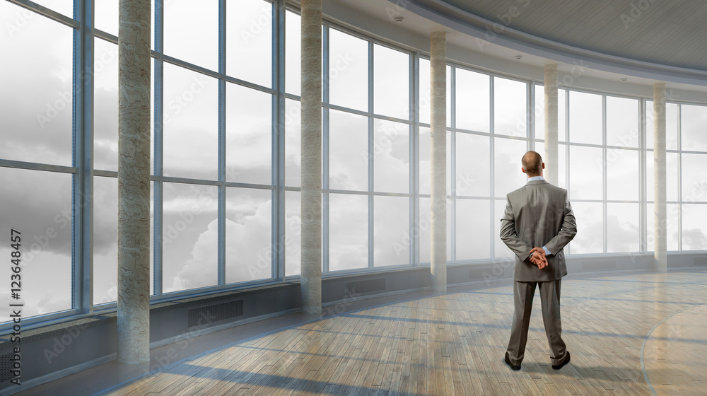 Pensive businessman in office . Mixed media Pensive businessman in office . Mixed media