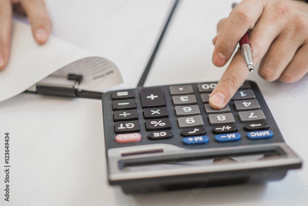 work on the calculator and papers close up work on the calculator and papers close up