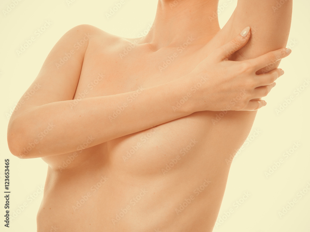 Fototapeta premium Woman examining her breasts for breast cancer