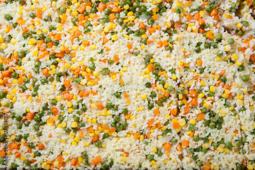 rice with vegetables. peas, corn and carrots © dechevm