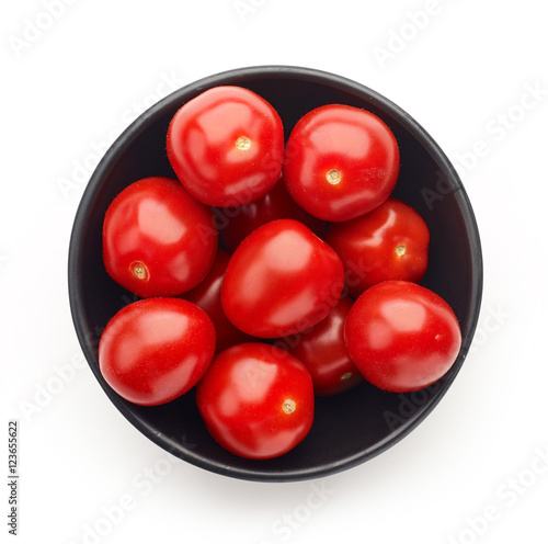 Bowl of tomatoes isolated on white, from above