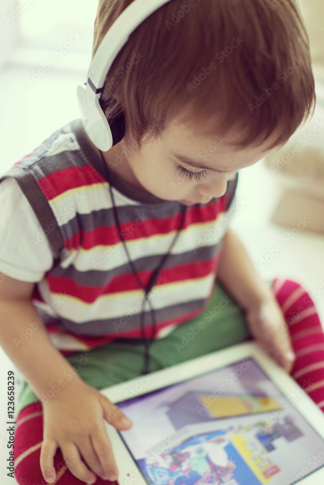 Kid playing with digital tablet Kid playing with digital tablet
