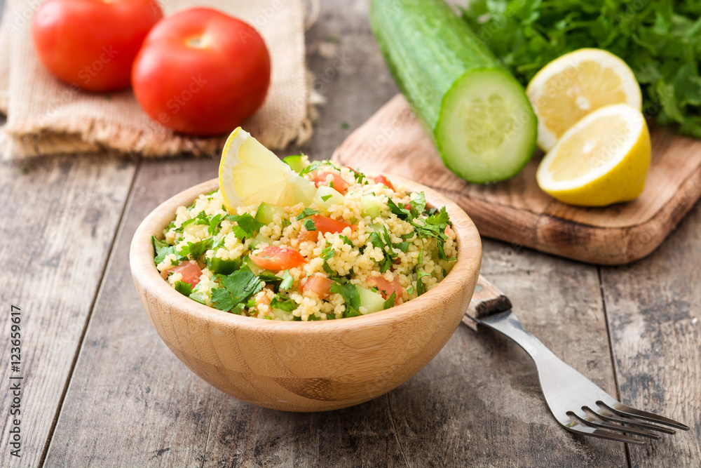Tabbouleh salad with couscous on rustic wooden table
Tabbouleh salad with couscous on rustic wooden table