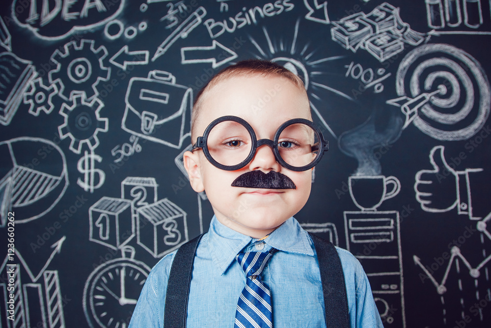 Little boy as businessman or teacher with mustache and glasses standing on dark background pattern. Wearing shirt, tie. close-up Little boy as businessman or teacher with mustache and glasses standing on dark background pattern. Wearing shirt, tie. close-up