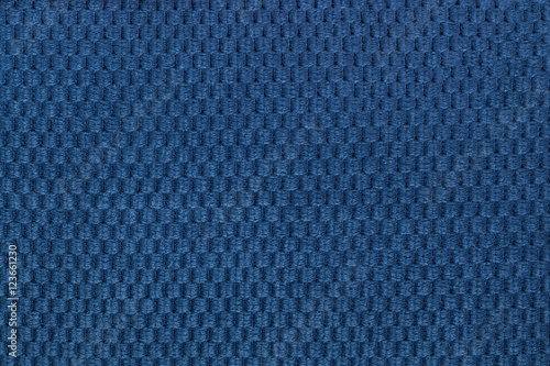 Dark blue background from soft fleecy fabric closeup. Texture of textile macro