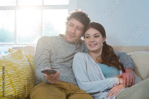 Couple watching television while sitting on sofa © WavebreakmediaMicro