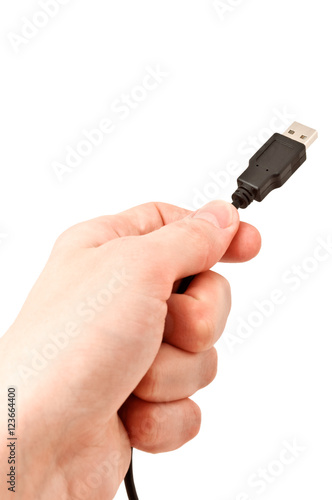 Hand holding USB cable. Isolated on white background