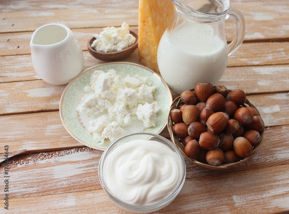 Ingredients for baking - milk eggs cheese nuts flour wheat, wood background Ingredients for baking - milk eggs cheese nuts flour wheat, wood background