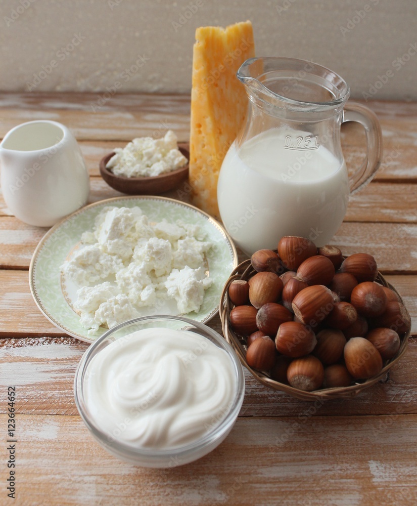 Ingredients for baking - milk eggs cheese nuts flour wheat, wood background Ingredients for baking - milk eggs cheese nuts flour wheat, wood background