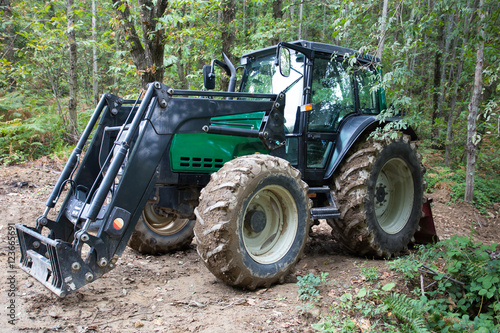 New modern agricultural tractor isolated in the woods