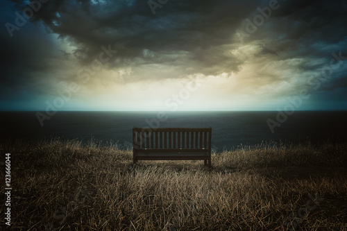 Bench in front of a dramatic cloudscape