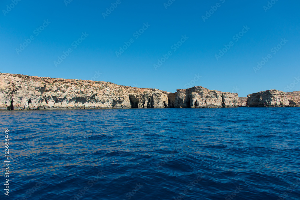 Island seen from the sea with a deep blue water