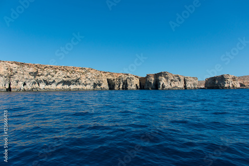 Island seen from the sea with a deep blue water