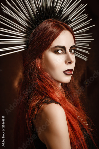 Closeup portrait of beautiful gothic girl wearing spiked headgear