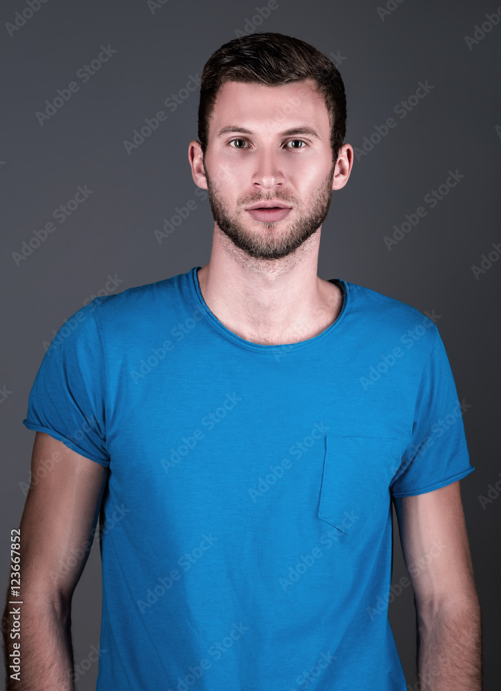 Fototapeta premium Studio fashion shot: portrait of handsome young man in blue shirt