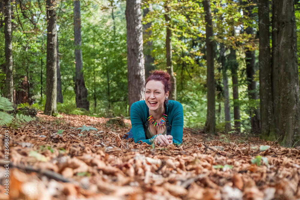 Girl on the leaves laying and smiling Girl on the leaves laying and smiling