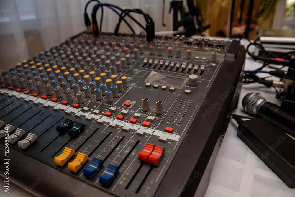 DJ console cd mp4 deejay mixing desk Ibiza house techno dance music wedding reception party in nightclub with colored lighting effect disco lights. DJ console cd mp4 deejay mixing desk Ibiza house techno dance music wedding reception party in nightclub with colored lighting effect disco lights.