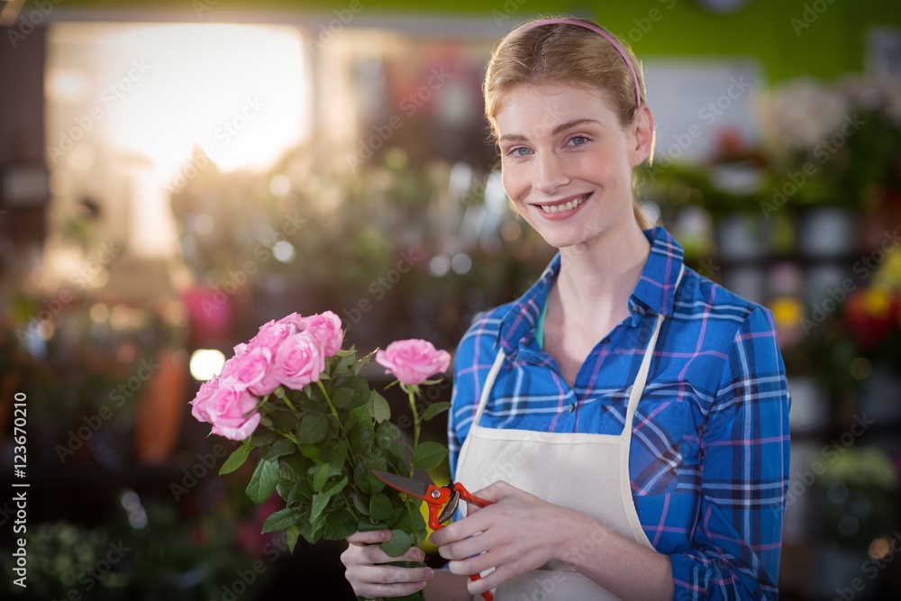 Fototapeta premium Female florist preparing flower bouquet