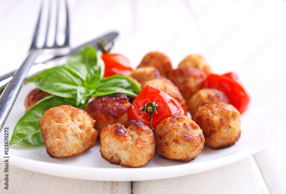 Meatballs with tomato in a white dish on a white background. selective focus. Meatballs with tomato in a white dish on a white background. selective focus.