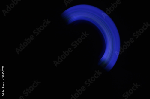 Fototapeta Naklejka Na Ścianę i Meble -  Light painting semicircle with blue light and black background 