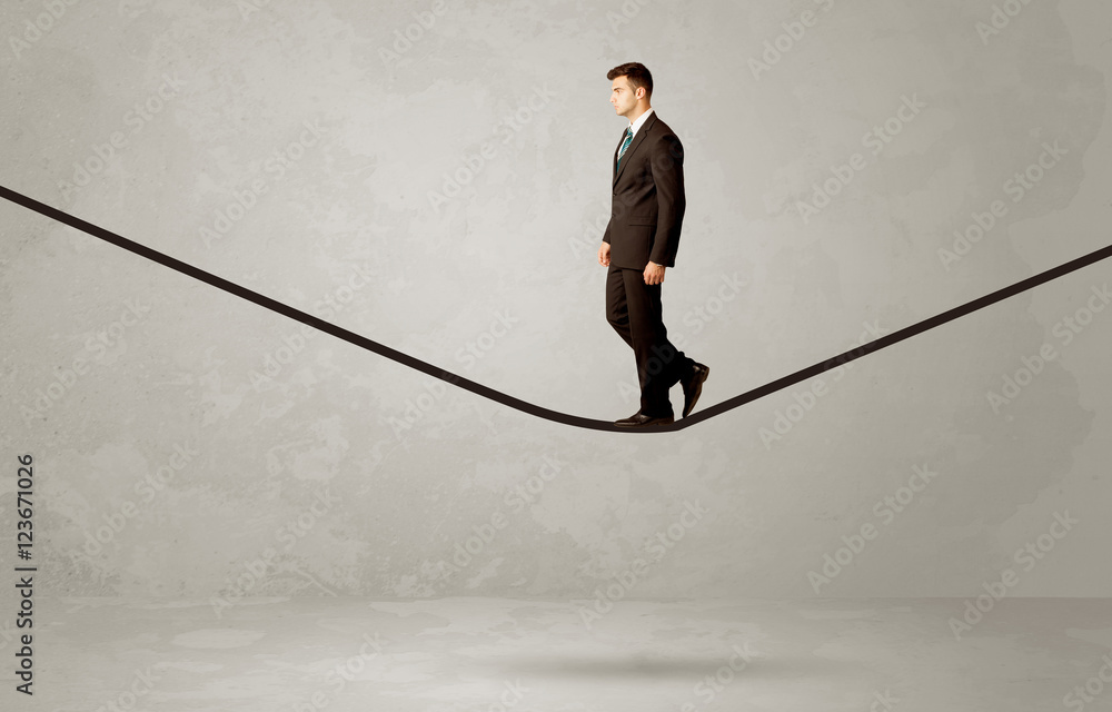 Salesman walking on rope in grey space Salesman walking on rope in grey space