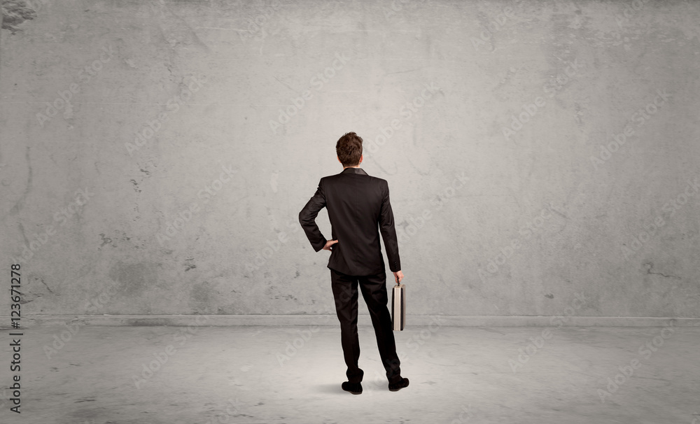Businessman lost in empty urban space Businessman lost in empty urban space
