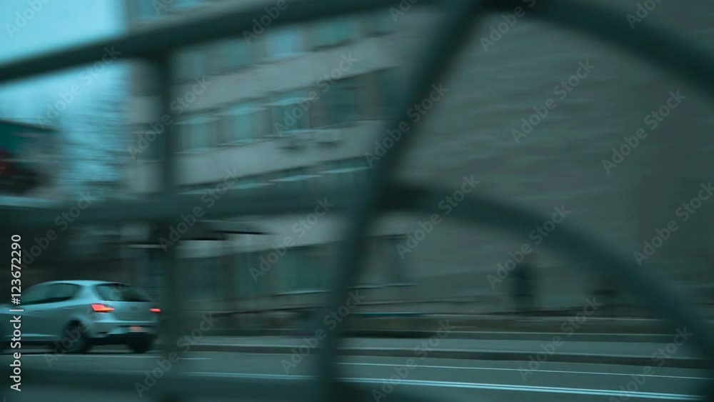 Side shot of a blue car driving in a city street in twilight Side shot of a blue car driving in a city street in twilight