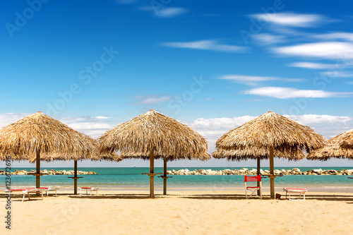Fototapeta Naklejka Na Ścianę i Meble -  Palm parasol on the beach in a sunny day