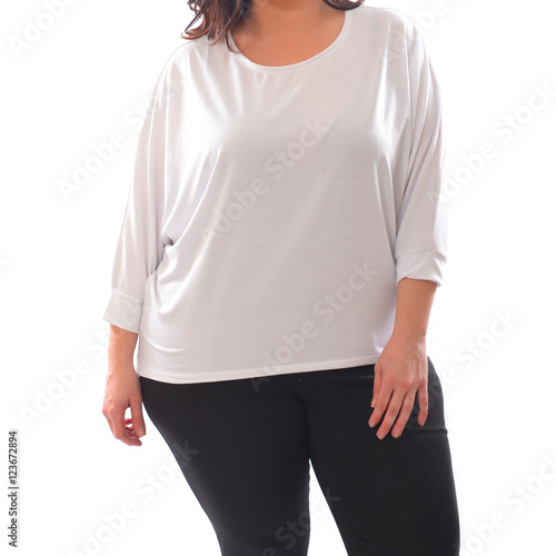 portrait of plus size model woman wearing XXL white sweater sweatshot and black leggins posing isolated on white background. photo