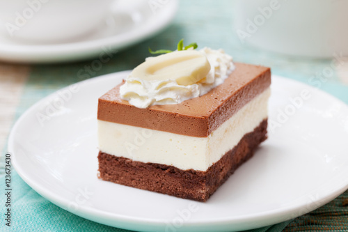 Three chocolate mousse cake on a white plate