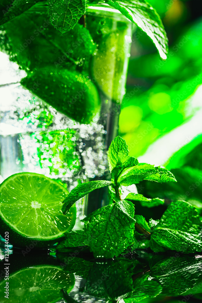 glass of mojito with lime and mint close-up ice cube on a dark background glass of mojito with lime and mint close-up ice cube on a dark background