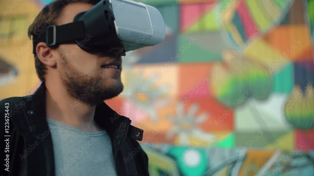 bearded attractive man a 3D Virtual Reality headset on a bright background 4k bearded attractive man a 3D Virtual Reality headset on a bright background 4k