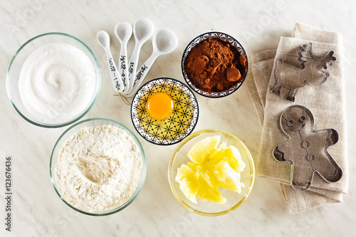 Ingredients for baking on a white marble table : flour, eggs, co