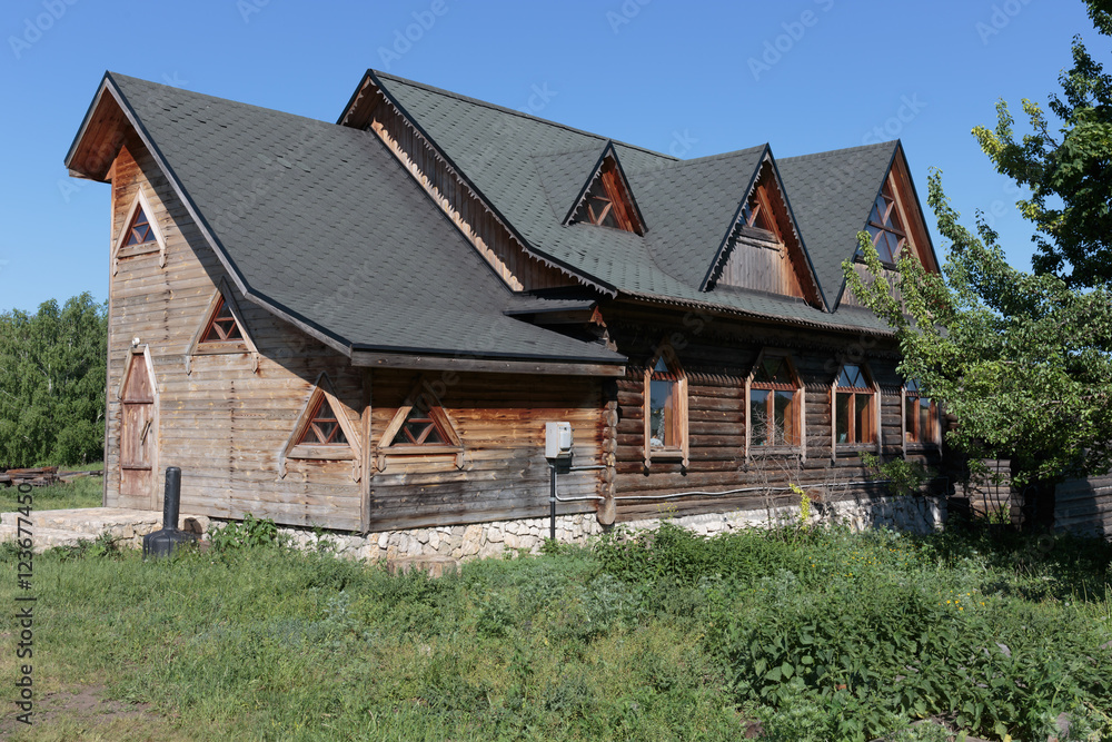 wooden house with a slate roof in the village