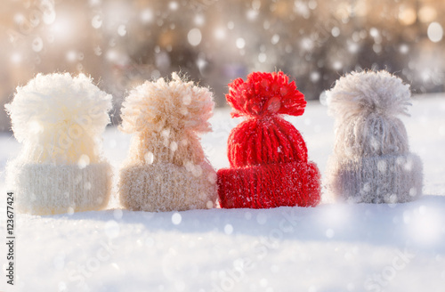 Woolen knitted hats on snow. Hello winter! Holiday background