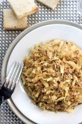 Fried cabbage with caraway and garlic on a plate