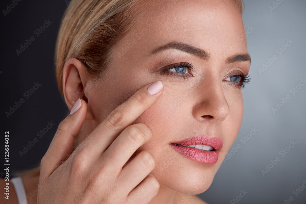 Fototapeta premium middle age woman checking her face