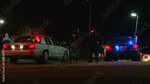Police officer and FBI agent downtown at crime scene.