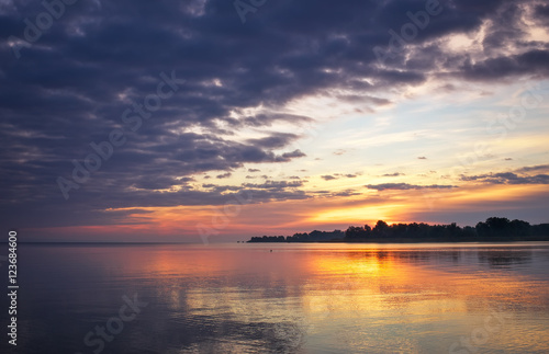 Beautiful landscape with sunset fiery sky and sea. 