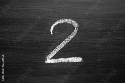 number two enumeration written with a chalk on the blackboard photo