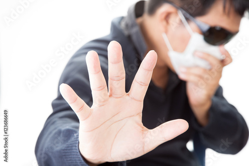 man with glasses and a medical mask and hand  in front of him photo