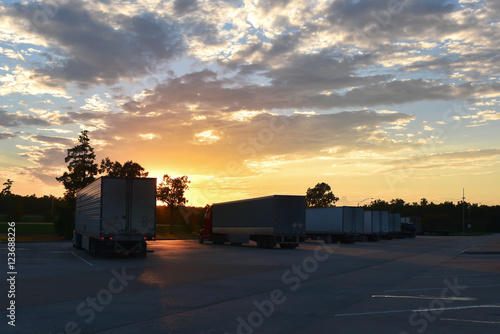 Semi trucks parking at rest area with beautiful evening sky background