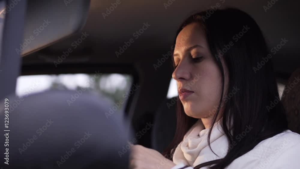 Woman applies makeup in the car Woman applies makeup in the car