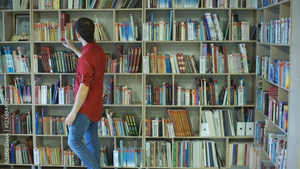 A male college student studies in the library A male college student studies in the library