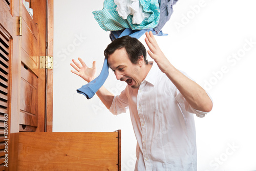 фотографія angry man throwing clothes
