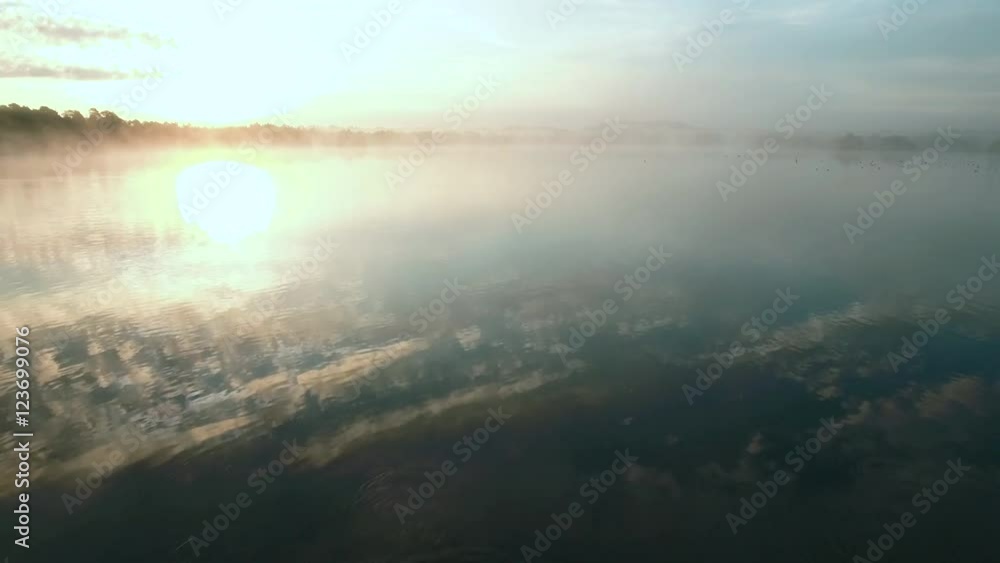 Follow Shot of Naked Man running and Jumping into Water Early at the Morning. Follow Shot of Naked Man running and Jumping into Water Early at the Morning.
