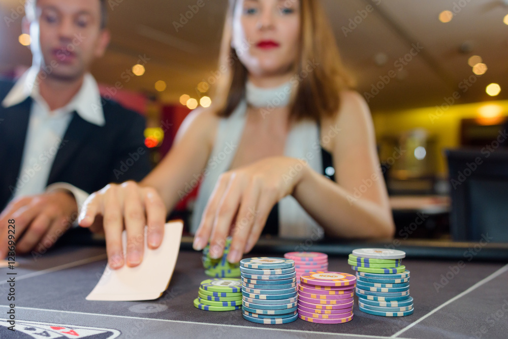 Fototapeta premium Couple playing card game in casino