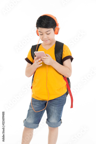 Happy asian boy using cell phone .